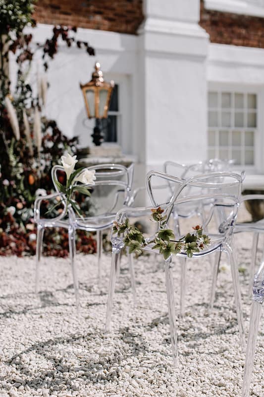 Image by <a class="text-taupe-100" href="http://www.rebeccagoddardphotography.com" target="_blank">Rebecca Goddard Photography</a> | Chairs by <a class="text-taupe-100" href="http://www.wedhead.co.uk" target="_blank">Wedhead</a>.
