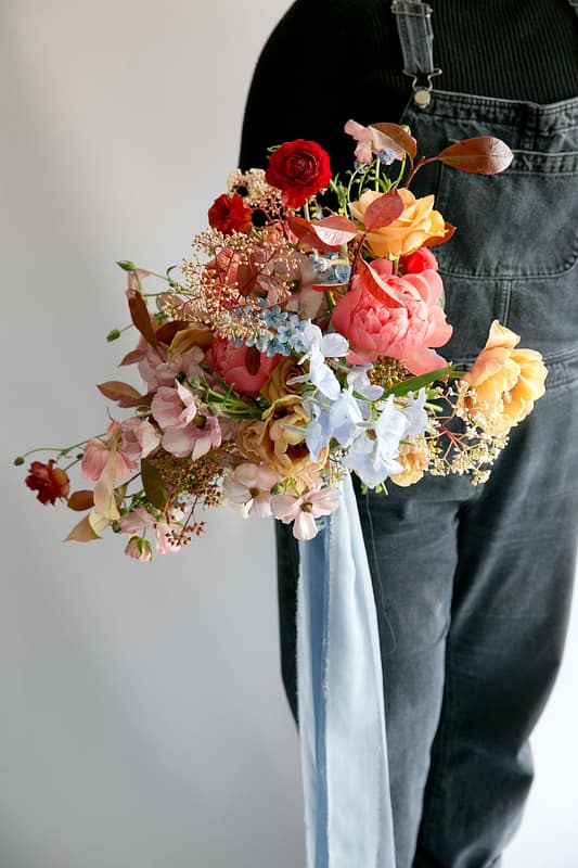 Image by <a class="text-taupe-100" href="http://www.corettefauxphotography.co.uk" target="_blank">Corette Faux Photography</a> | Flowers by <a class="text-taupe-100" href="https://jennibloom.com" target="_blank">Jenni Bloom Floral Design Studio</a>.